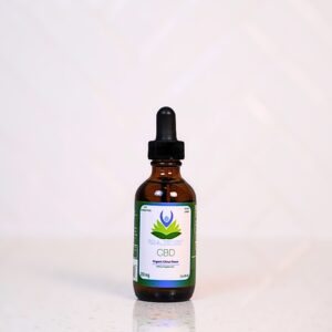 A bottle of cbd oil sitting on top of a table.