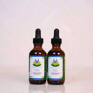 Two bottles of cbd oil sitting on a table.