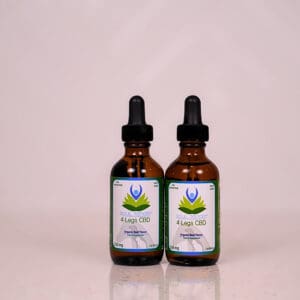 Two bottles of oil sitting on top of a table.