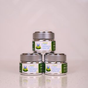 Three small containers of cream sitting on top of a table.