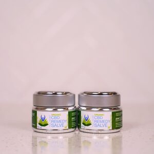 Two jars of green tea are sitting on a table.