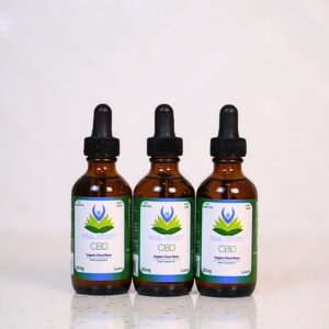Three bottles of cbd oil sitting on a table.