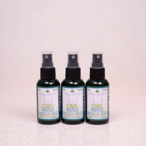 Three bottles of oil sitting on a counter.